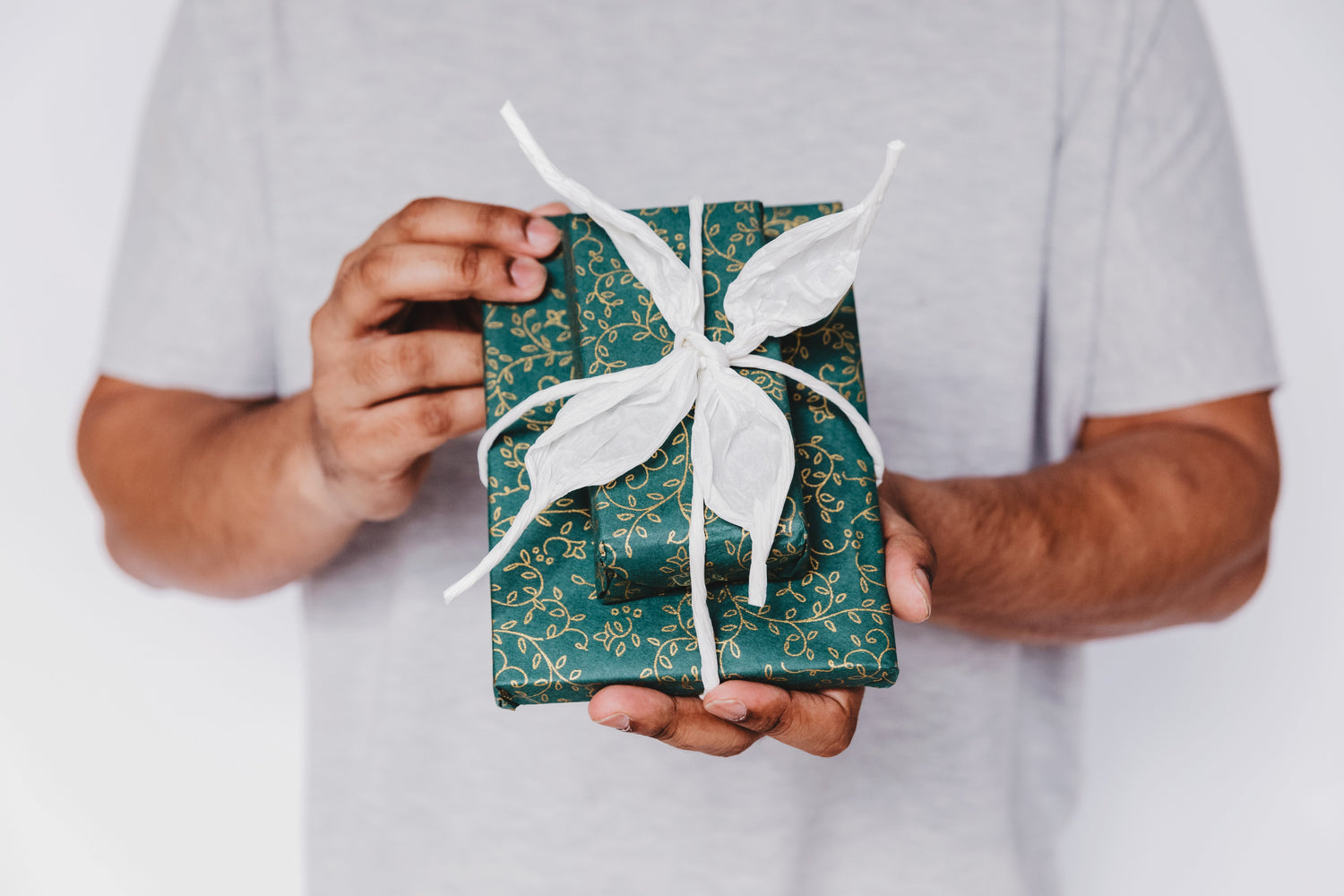 two packages wrapped with white ribbon